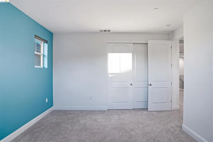 Unfurnished bedroom featuring carpet floors and a closet