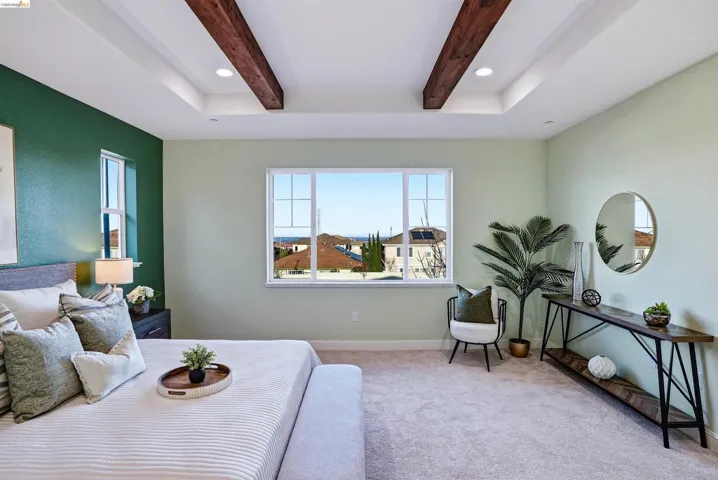 Bedroom with light colored carpet, recessed lighting, and beam ceiling