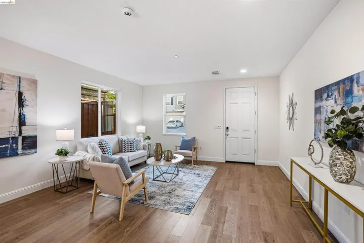 Living area with wood finished floors and recessed lighting