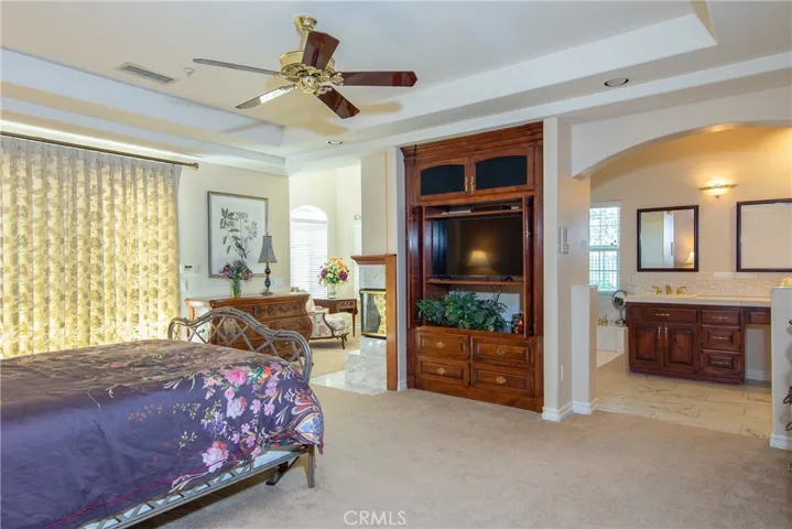 Primary suit with sitting area and wet bar and primary bathroom
