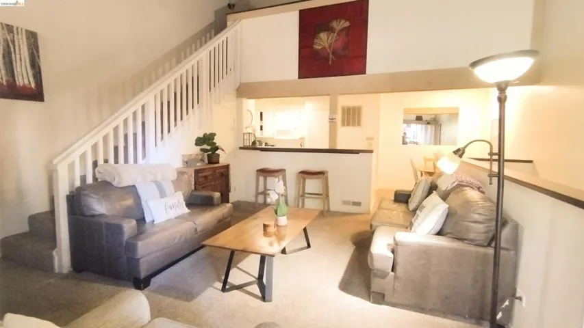 Living area featuring carpet floors and a high ceiling