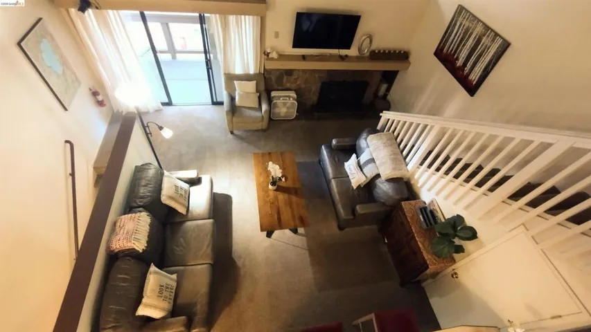 Living area with carpet and a fireplace
