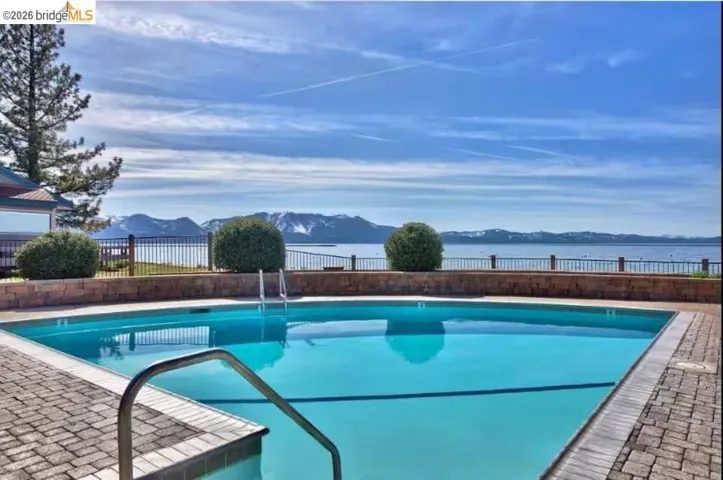 Community pool with a mountain view and a patio area