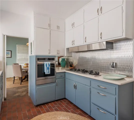 Updated kitchen with many new appliances, sleek backsplash, and abundant cabinetry—blending modern function with coastal charm.