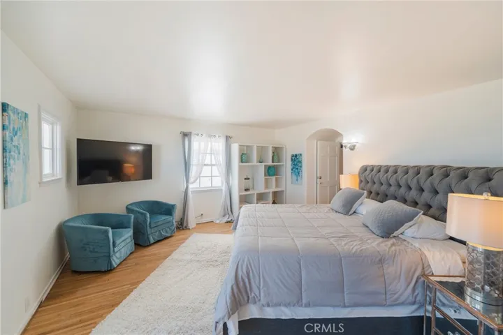 Spacious primary bedroom with a super comfortable king bed, soft coastal tones, and plenty of room to relax after a day at the beach.