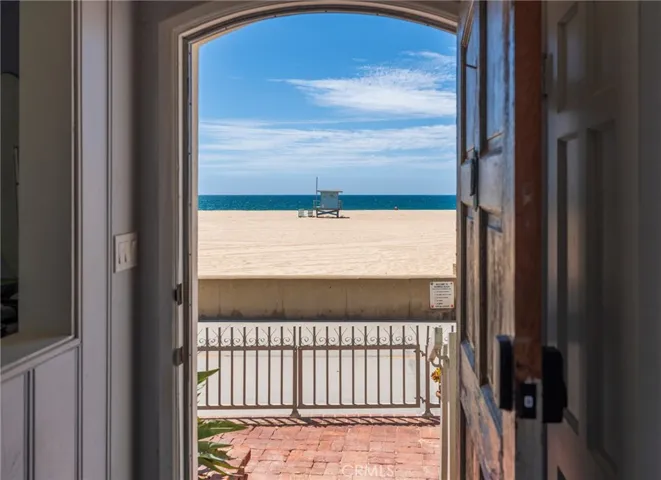 Welcoming entry with a direct ocean view, opening to the patio and beach just beyond—true indoor-outdoor coastal living.