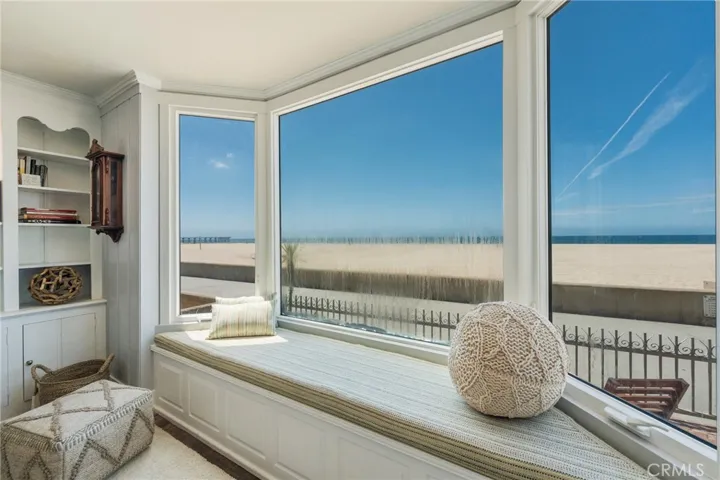 Bright ocean-view sunroom with built-in window seating—perfect for relaxing and taking in the beach. Window currently being replaced.