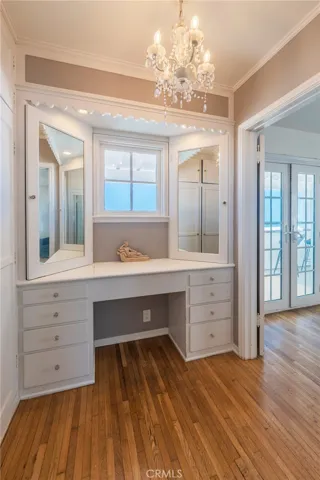 Elegant makeup vanity with ample storage and mirrors—perfect for the one who wants it all, complete with an ocean view.