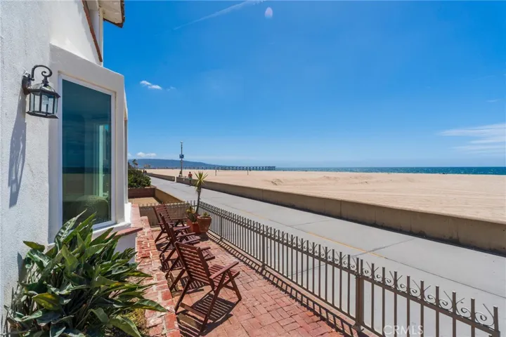 Oceanfront patio with seating just off the Strand, offering front-row views of the beach and a perfect spot to relax and enjoy the coastal lifestyle.