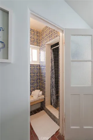 Alternate view of downstairs showers featuring imported Spanish tile—ideal for convenient off-the-beach use.