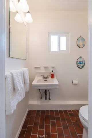 Two beautifully tiled Spanish-style showers are located just steps from this bathroom and adjacent bedroom—ideal for rinsing off after the beach while keeping everything easy and accessible.