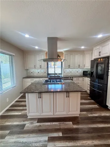 Kitchen offers all the amenities! Modern hood, granite counters, high end appliances and plenty of cabinets