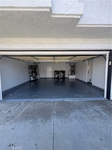 2 car garage with Epoxy coated floor and access to backyard.