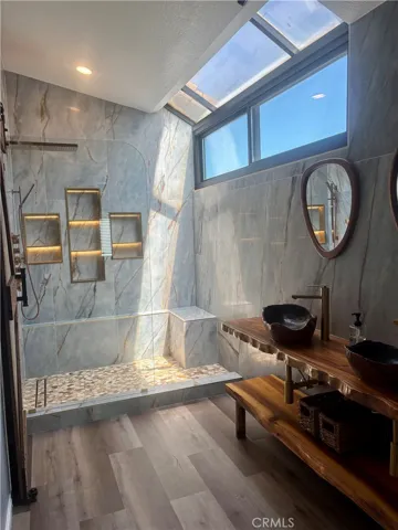 Spa like bathroom with walk-in shower and plenty of natural light.