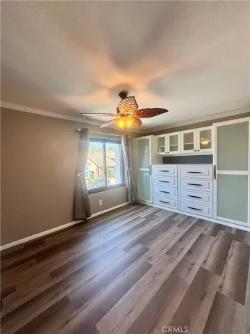 Bedroom #3 with built-in cabinets and closet space. Ceiling fan