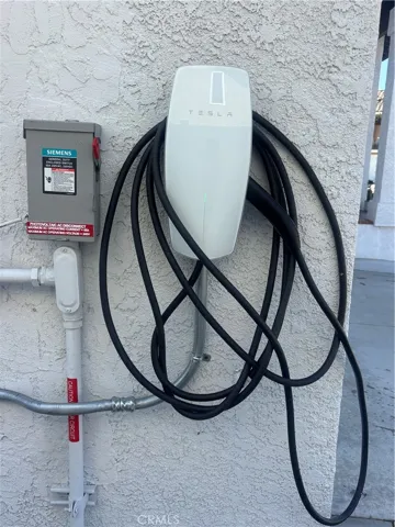 Tesla charger on side of home