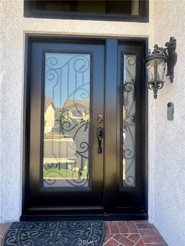 Custom glass and iron decor front door sets the stage for the interior.