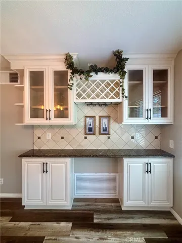 Built-in buffet/side board with cabinets and wine rack.