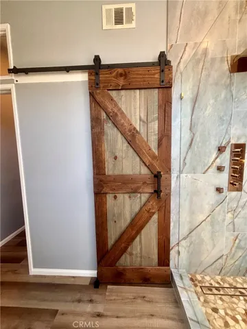 Sliding barn door opens to a walk-in closet