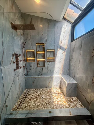 The perfect shower! Plenty of natural light, space, shower bench and lit up storage spaces.