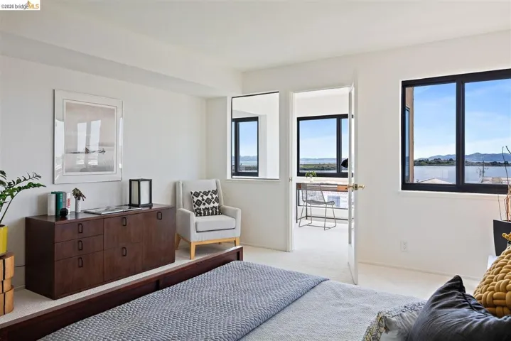 Bedroom with carpet flooring, multiple windows, and a mountain view