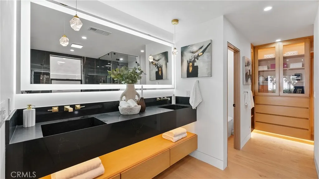 Enjoy a true retreat in the primary bathroom with steam shower, dual custom vanity sinks, and custom walk-in closets.