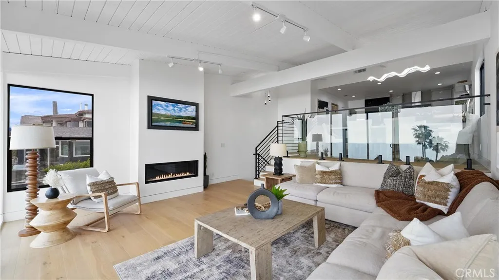 Light-filled living room with an open and airy feel, showcasing ocean and white-water views.