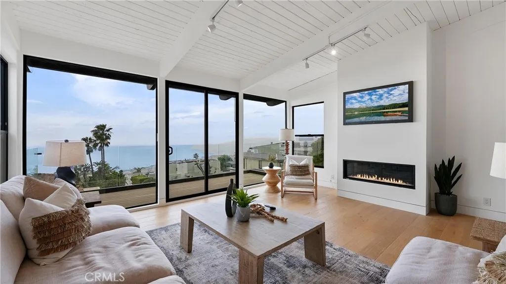 A perfect space to relax, gather, and enjoy the coastal lifestyle with ocean views from the living room and attached balcony.