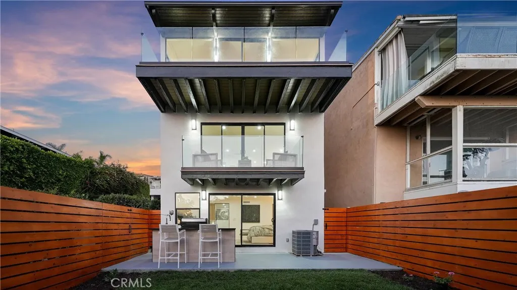 A great setting for indoor-outdoor coastal living with a custom-designed BBQ and beautifully updated landscaping
