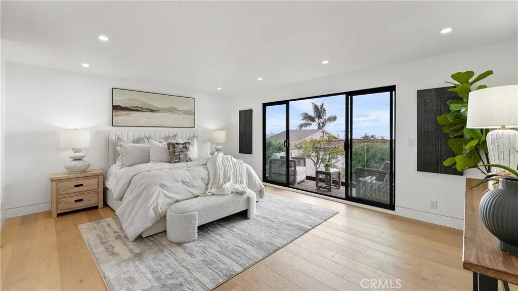 Primary bedroom with its own balcony, offering ocean views and a beautiful white-water backdrop.
