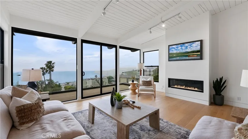 A perfect space to relax, gather, and enjoy the coastal lifestyle with ocean views from the living room and attached balcony.
