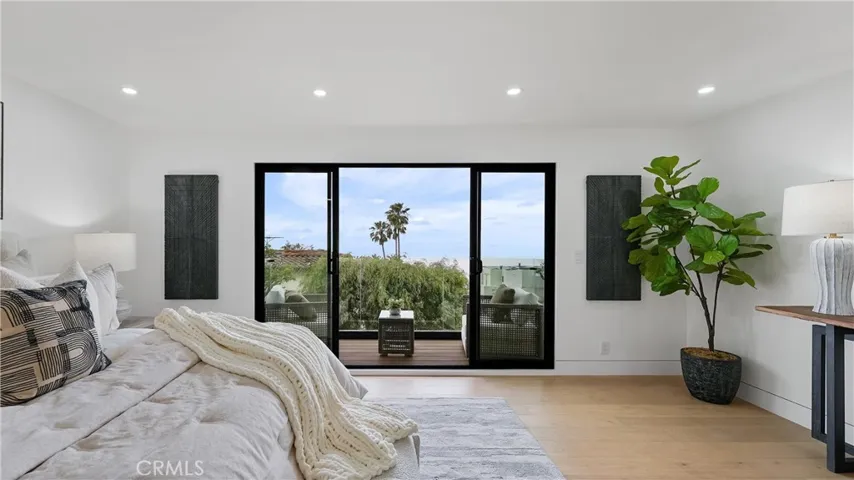 Comfortable primary bedroom with a peaceful atmosphere, ocean views, and balcony access.