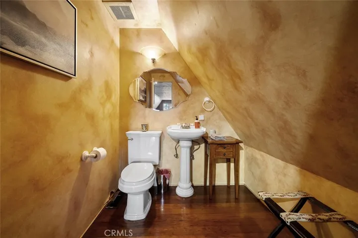 Upstairs half bathroom. There is room beyond the wall towards the back and to the side if one wanted to create a 3/4 bathroom.