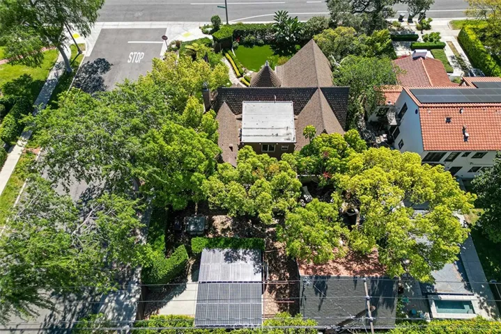 Paid solar doubles as a covered area over the driveway. Bright roof framed among the trees is the upstairs apartment.