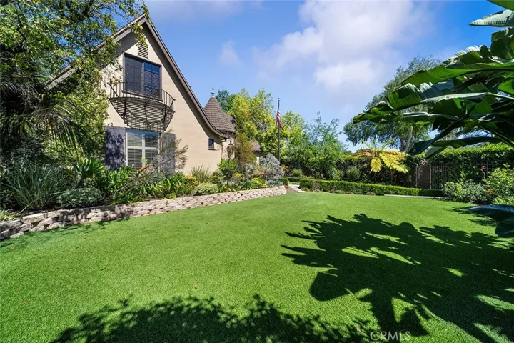 Spacious front yard with privacy hedges.