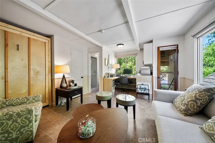Upstairs apartment includes Murphy bed, couch, chair, built in desk adn small refrigerator.