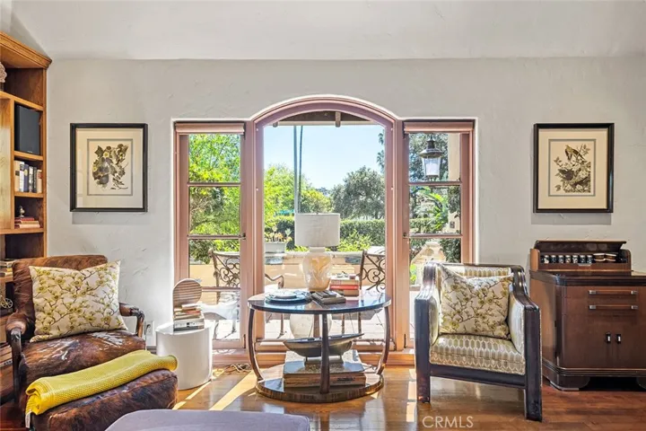 Picture perfect large window with front porch overlooking the landscape and set privately with high hedges.