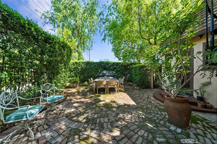 Whimsy pattern of brick pavers. Looking towards Martelo Ave. High hedges offers privacy.