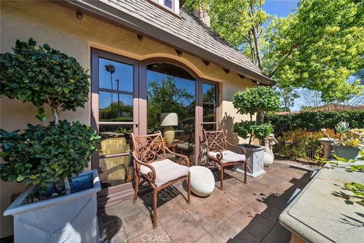 Just enough space to sit and enjoy the landscaped private front yard with high hedges.