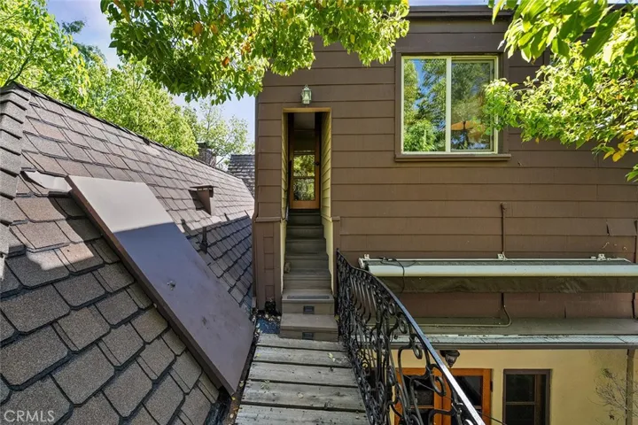 Door to upstairs apartment. French doors bottom right leads to the dining room.
