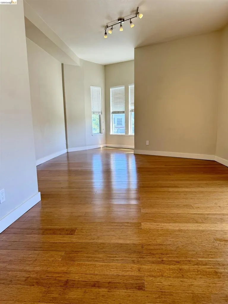 Spare room featuring light wood-style floors and baseboards