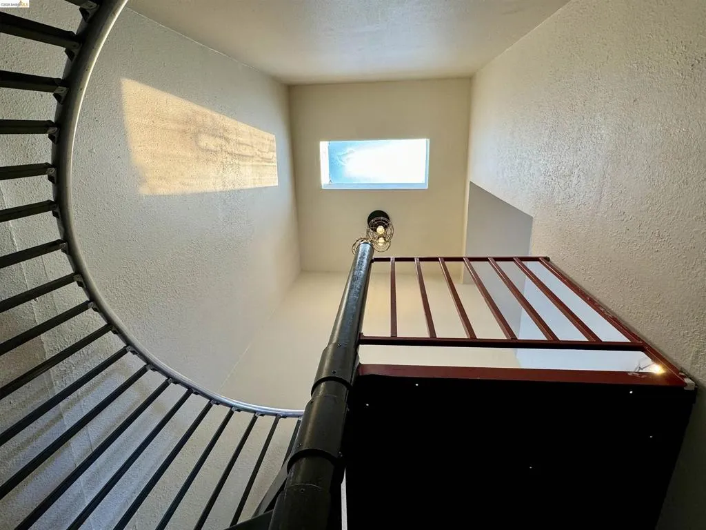 Stairway featuring a textured wall