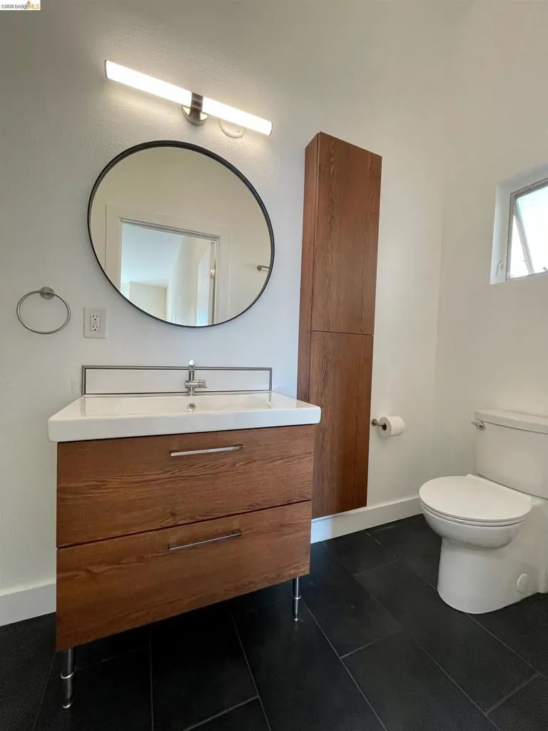 Bathroom with vanity and dark tile patterned floors