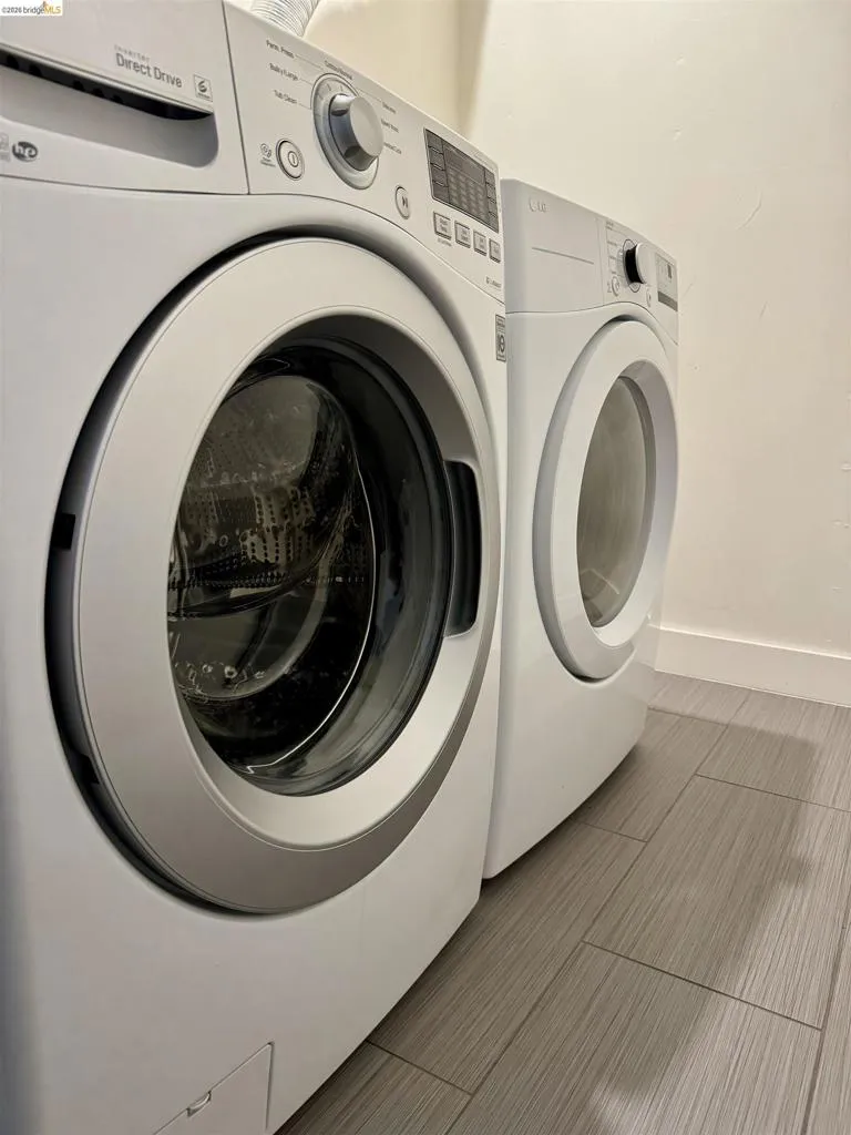 Laundry room with washer and dryer and baseboards