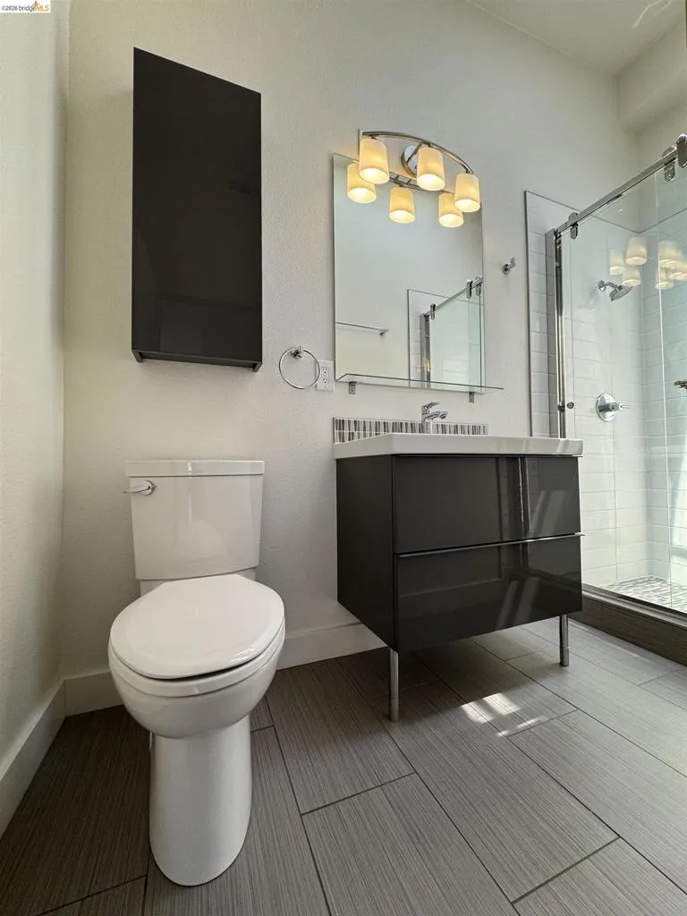Full bathroom featuring a shower stall and vanity