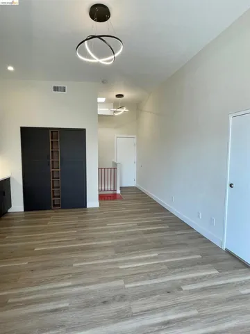 Unfurnished room with light wood finished floors and baseboards