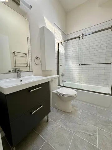 Bathroom featuring vanity and enclosed tub / shower combo
