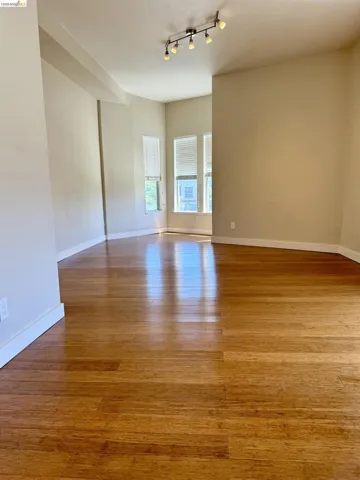 Spare room featuring light wood-style floors and baseboards