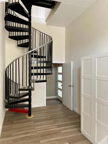 Stairs featuring a high ceiling and wood finished floors