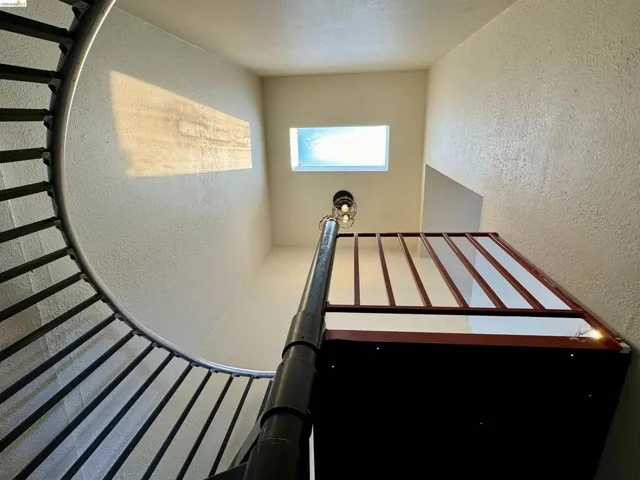 Stairway featuring a textured wall